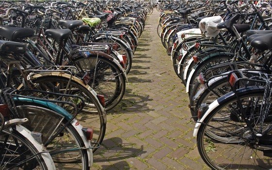 Some parked bikes near a train station