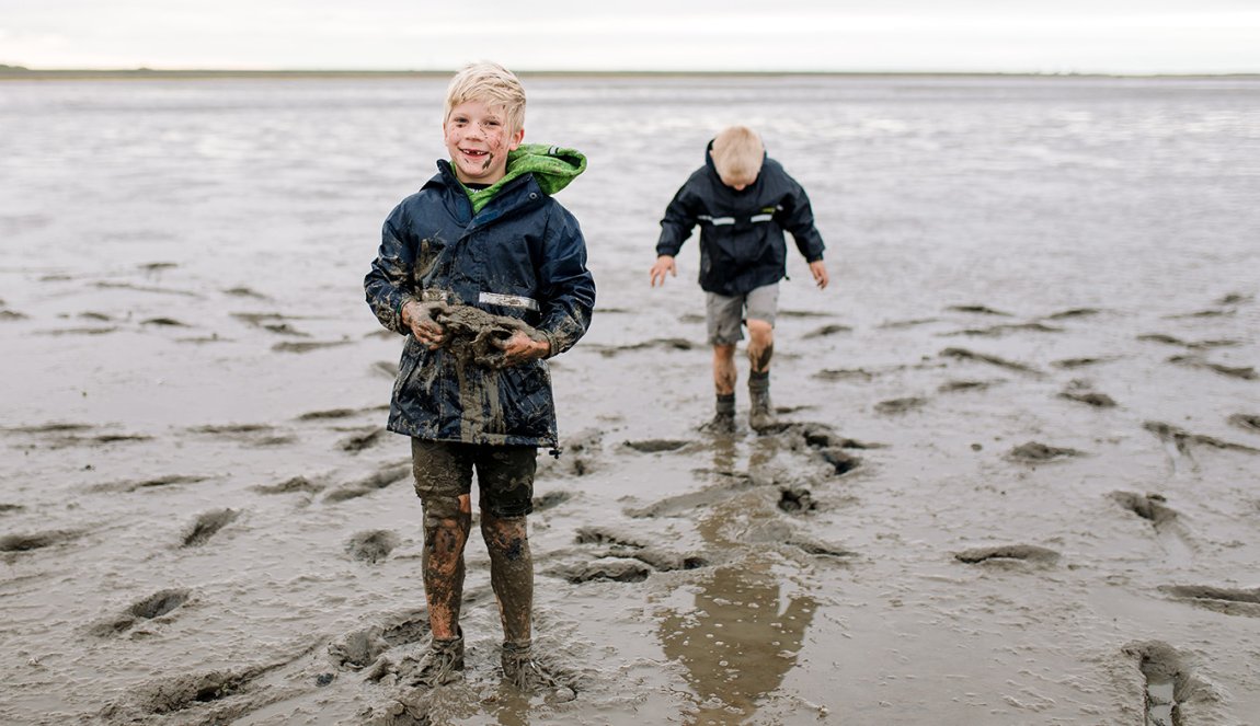 Wadden walking with kids boys covered in mud 