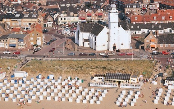 a birds eye view over the church and beach of katwijk