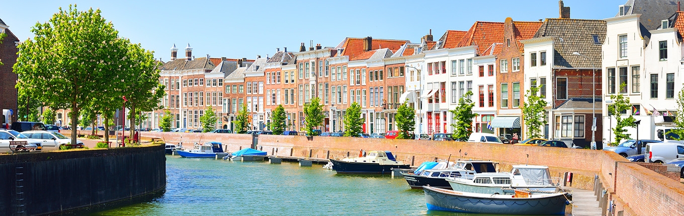 View of Middelburg with beautiful houses and boats along the canal.