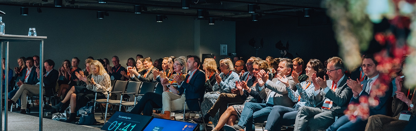 Visitors of an event watching the stage