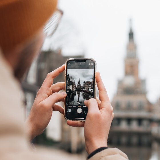 Person takes a photograph of the Waag in Alkmaar