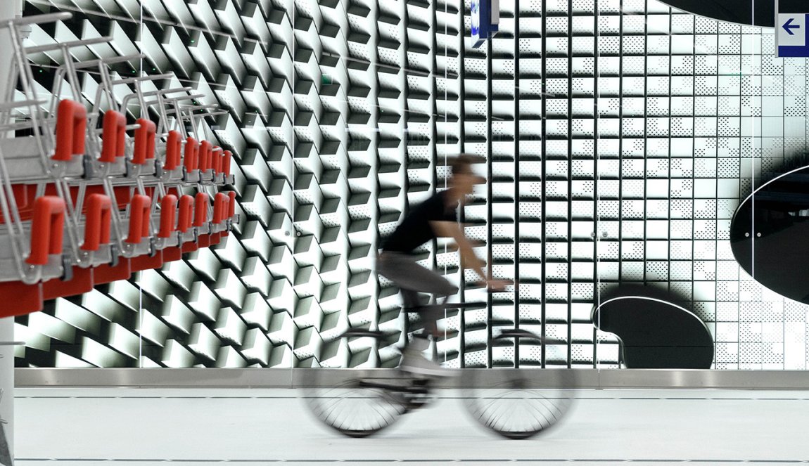 Cyclist bike through bike parking lot The Hague Koningin Julianaplein designed bij Silo