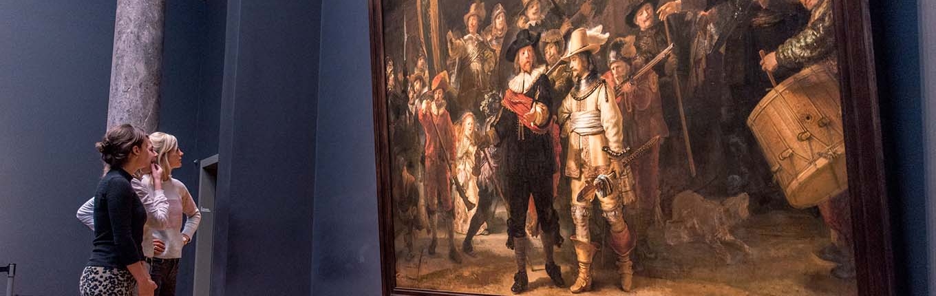 Visitors view painting De Nachtwacht by Dutch painter Rembrandt van Rijn