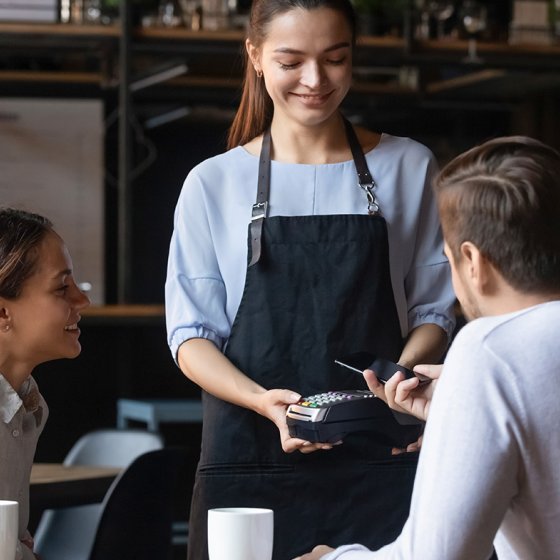 Couple in restaurant paid with mobile phone contactless payment