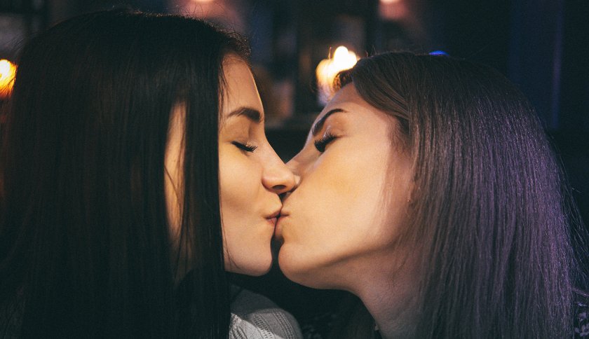 Women with brown hair kissing