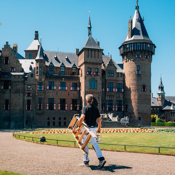Paul Hoogstraten walking with stairs in front of castle