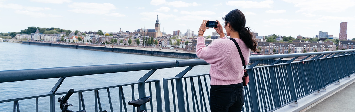 Bicyclist takes photo from bridge Bicyclist takes photo from bridge