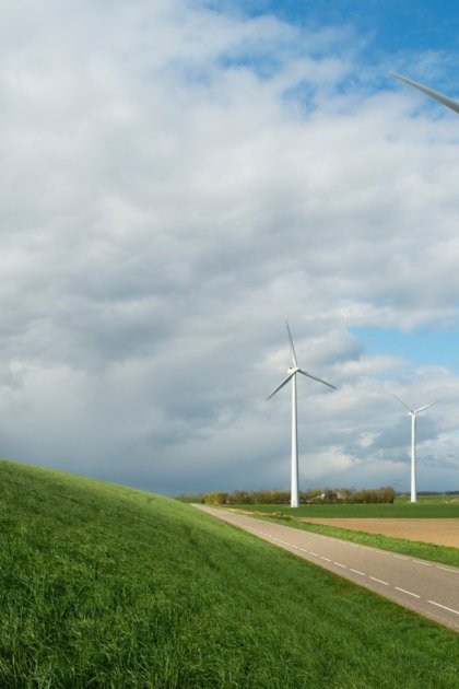 Cyclist next to wind turbines