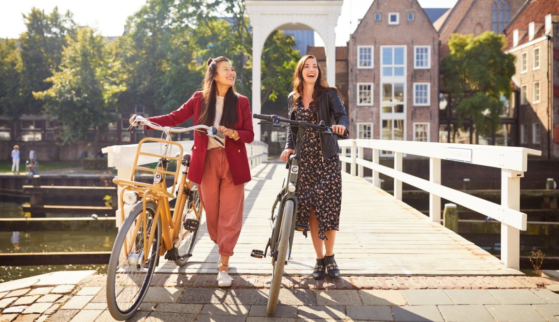 Young ladies with bicycle in Hanseatic city Zwolle 