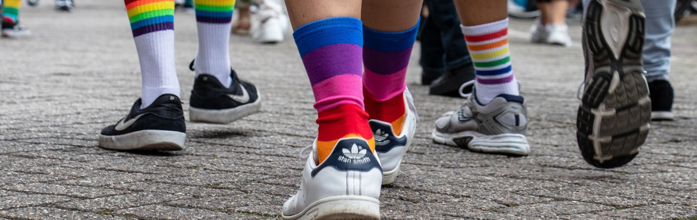 People with rainbow socks walking on the street