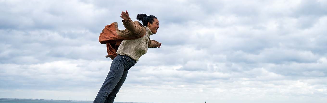 Woman hangs against strong headwinds in Zeeland