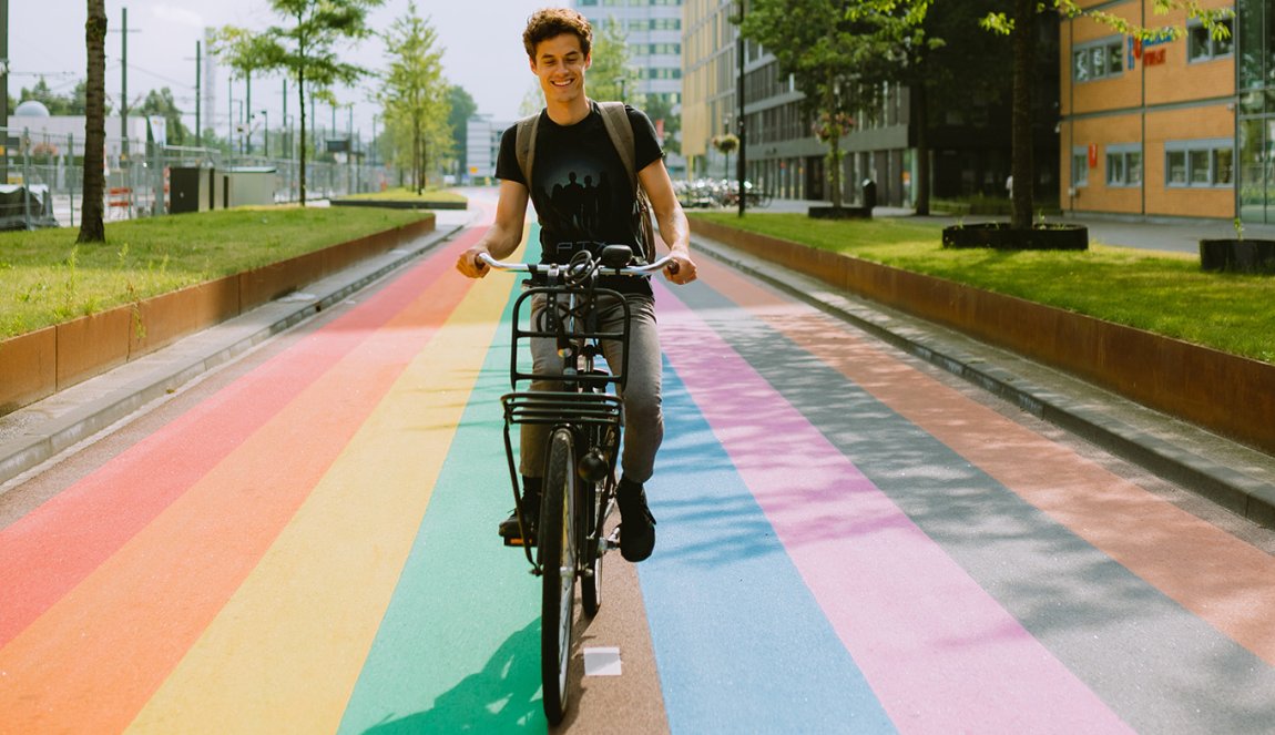 Man cycles along rainbow bike path in Utrecht
