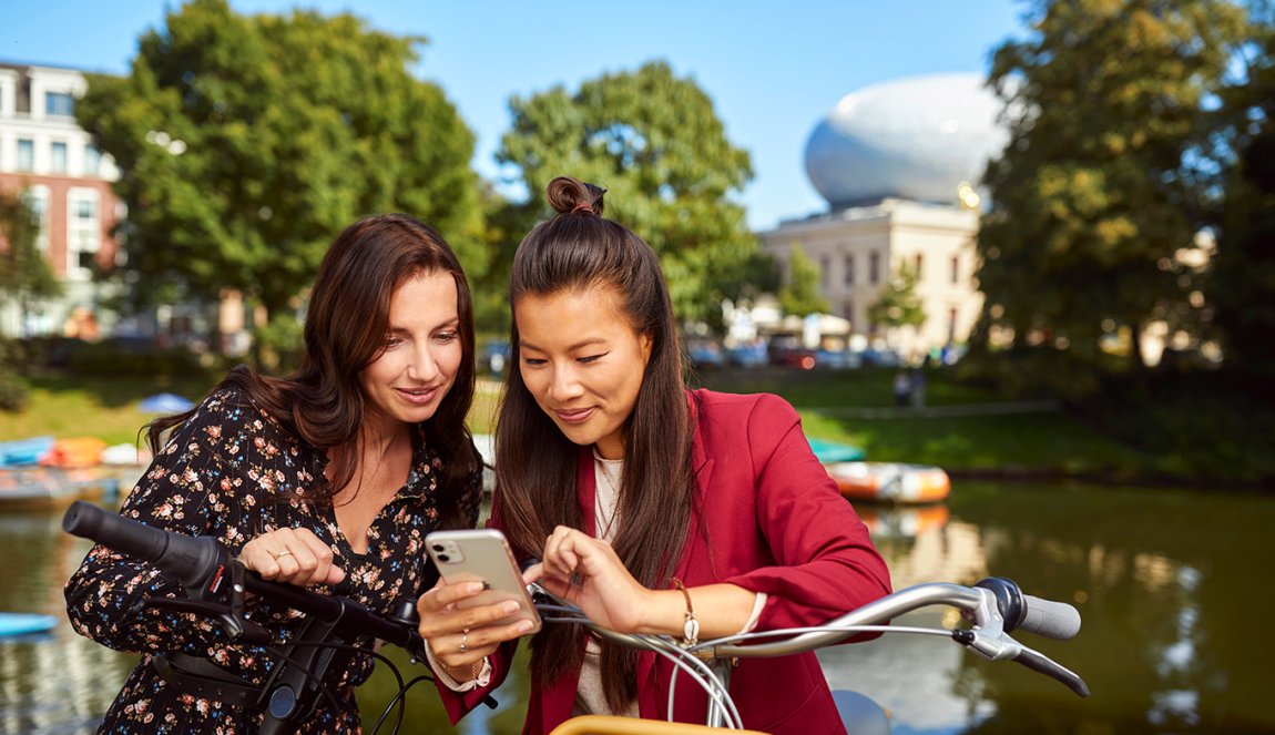 Ladies with mobile in front of the Fundatie in Zwolle Hanseatic cities