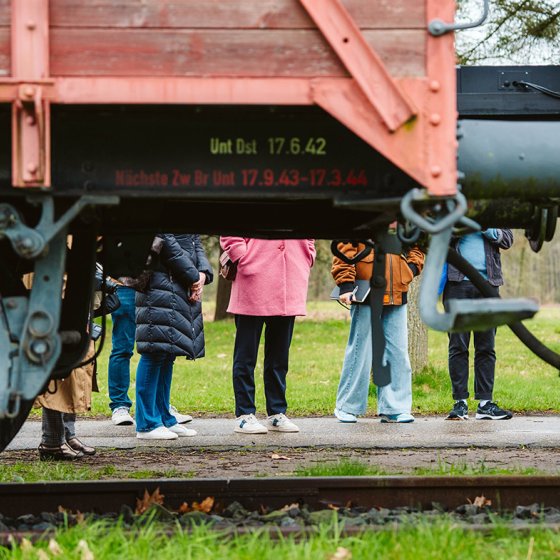 Visitors behind train at Kamp Westerbork Assen
