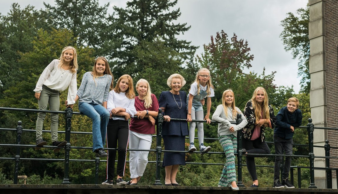 Princess Beatrix posing with her grandchildren on a bridge