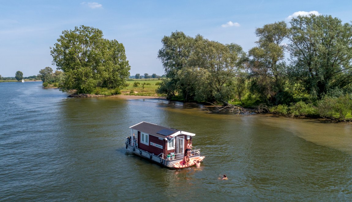 Camping on the water in a floating log cabin boat Camping on the water in a floating log cabin boat