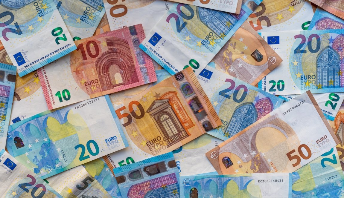 Banknotes on the table in denominations of twenty euros, fifty euros, ten euros, five euros.