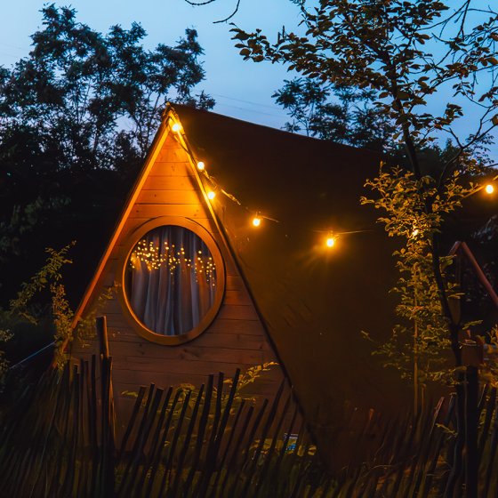 Charming forest cottage at dusk &mdash; Scandinavian accommodation in the Achterhoek region