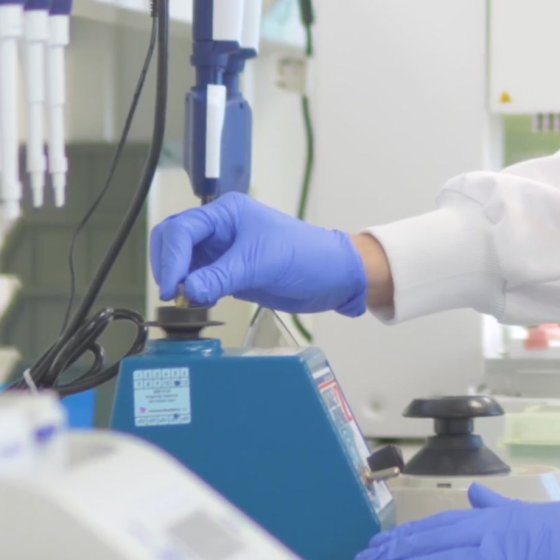 Laboratory researcher working with biotechnology equipment at Dutch AI biotech company Cradle