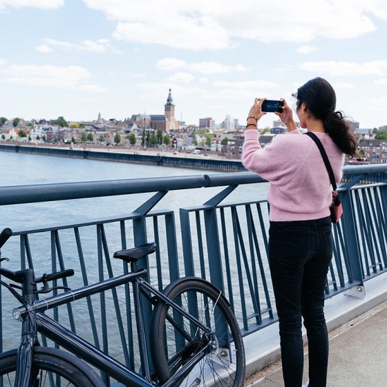 Bicyclist takes photo from bridge