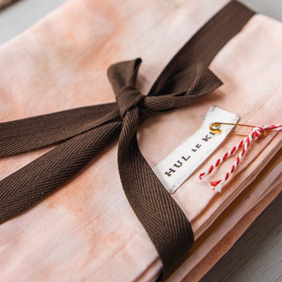 Hul le Kes stack of textiles with bow