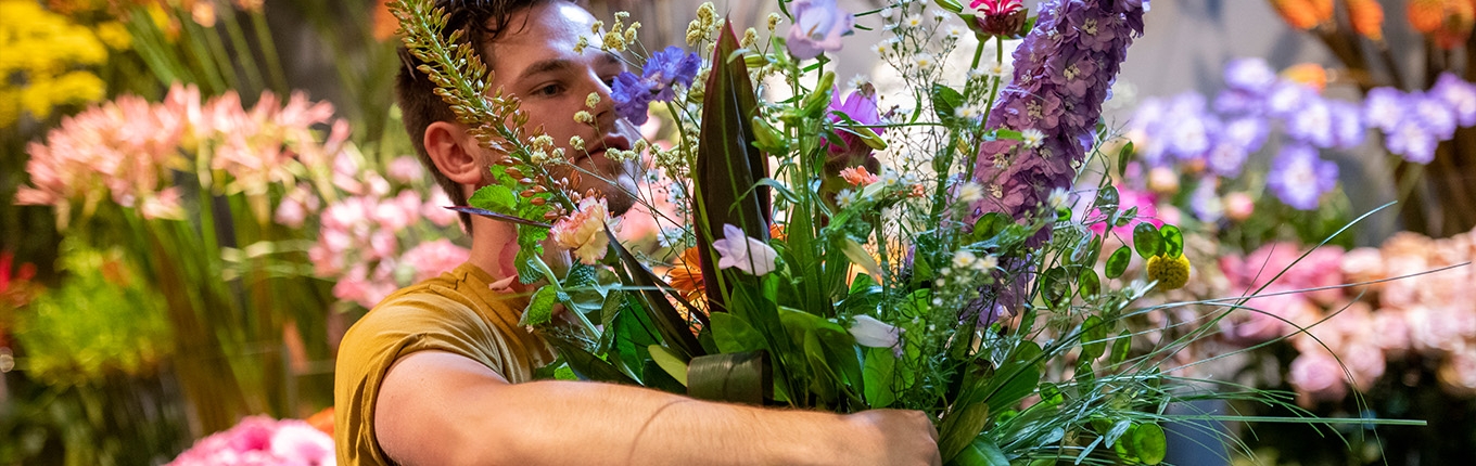 Arranging flowers. Big bunch of flowers in arms. Arranging flowers. Big bunch of flowers in arms.
