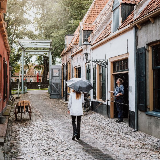 Lady walks through characteristic street Enkhuizen