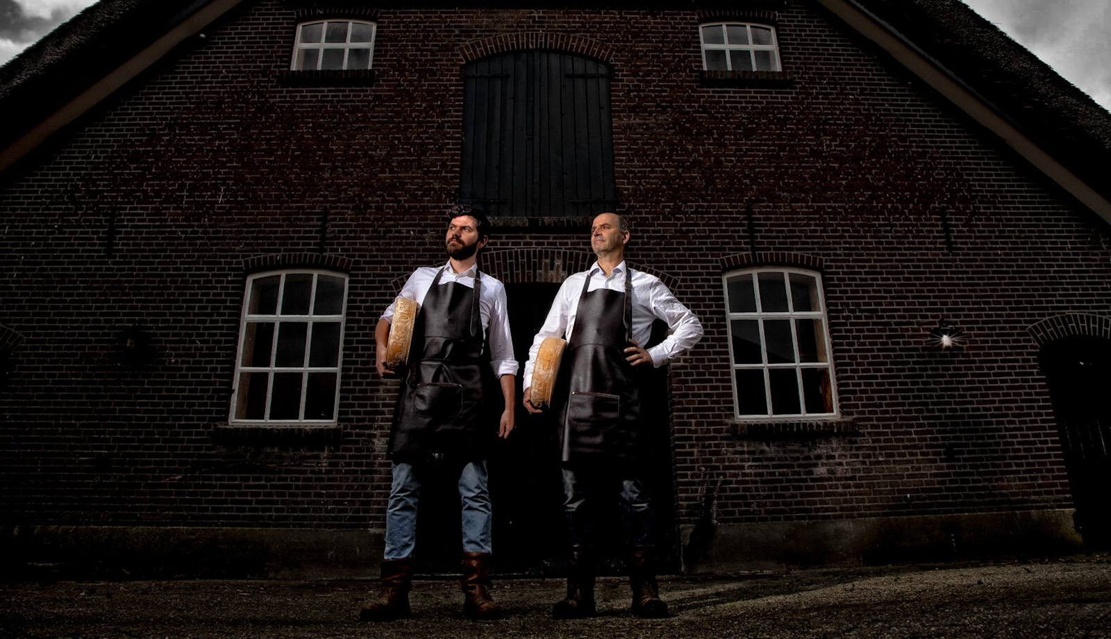 Father and son in front of De Groote Voort farm in the Gelderse Vallei with Remeker cheese Father and son in front of De Groote Voort farm in the Gelderse Vallei with Remeker cheese
