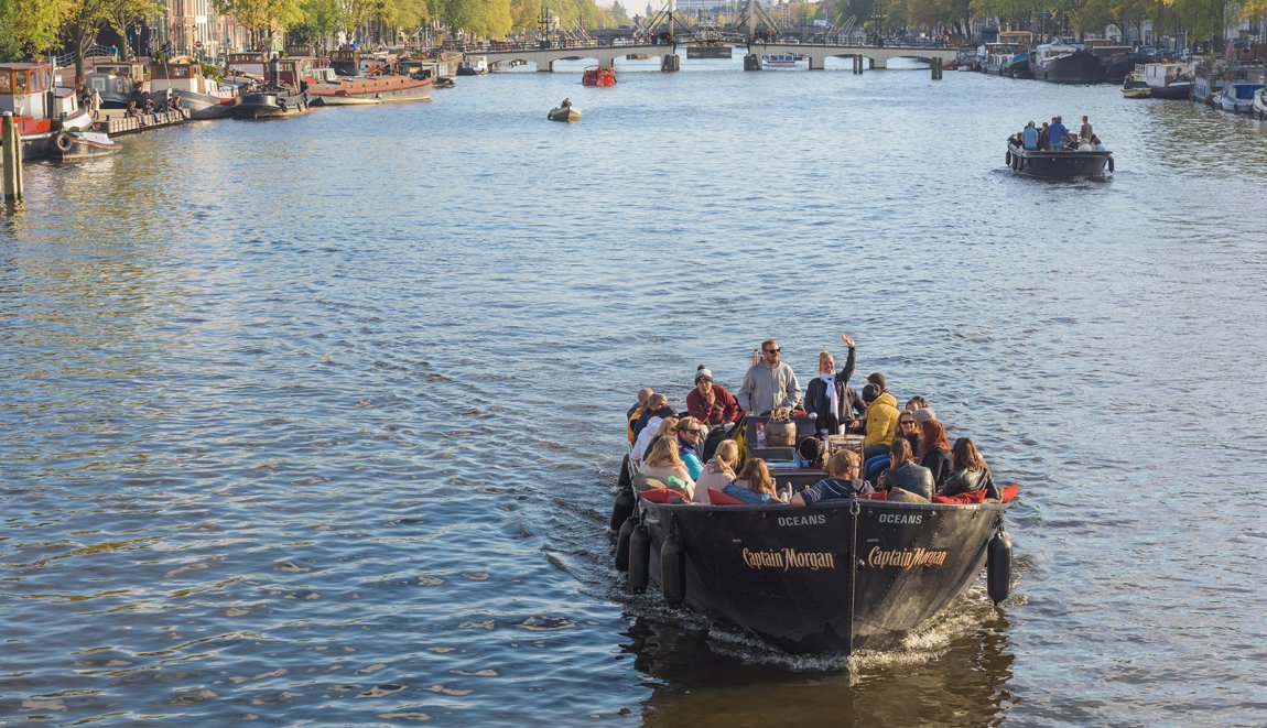 Group of visitors at canal open boat excursion