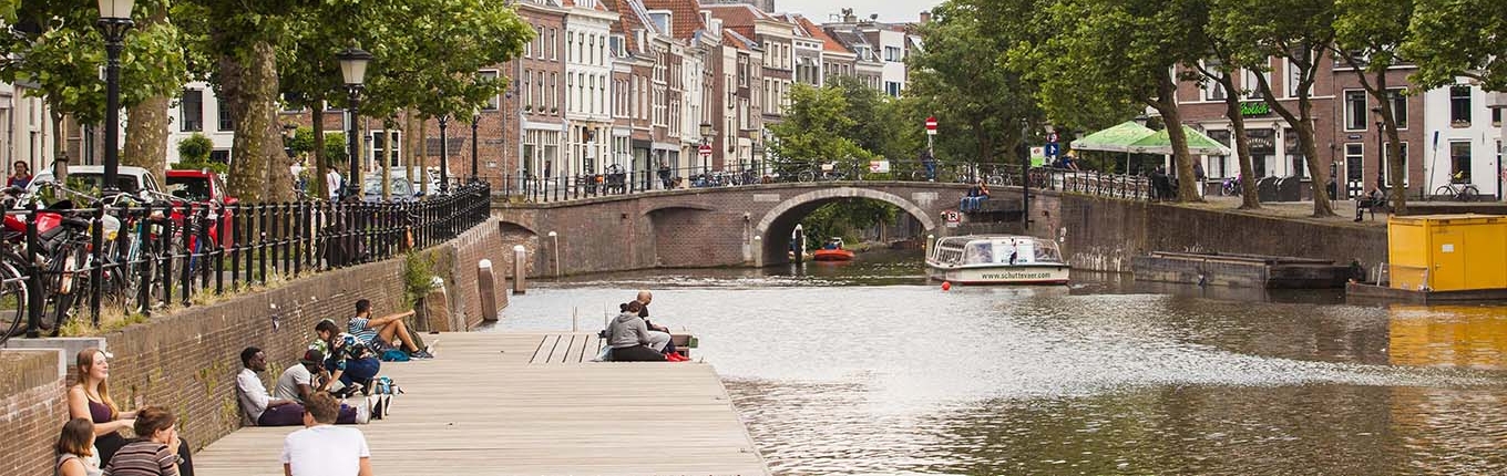 People enjoying the canal and sitting on the wharves People enjoying the canal and sitting on the wharves