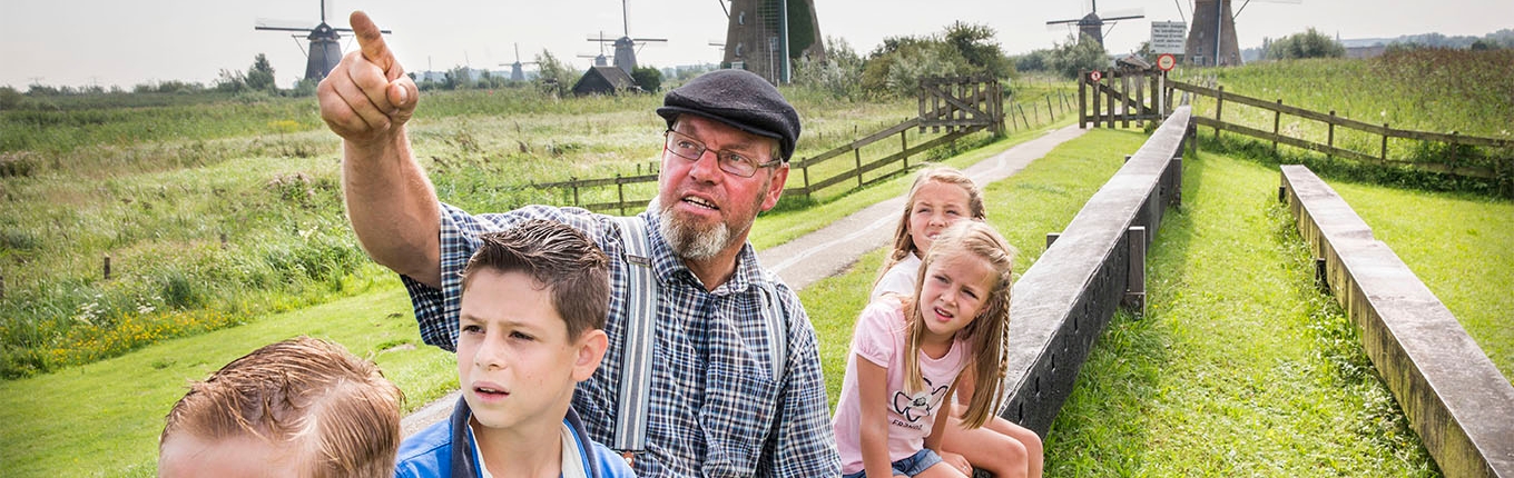 Kids looking at windmills miller tour at kinderdijk Kids looking at windmills miller tour at kinderdijk