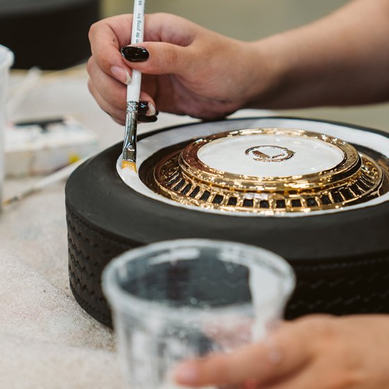 At work in Studio Job with white paint on wheel with gold 