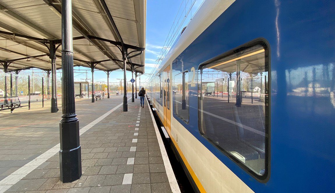 Someone walks to the train at NS station Geldermalsen