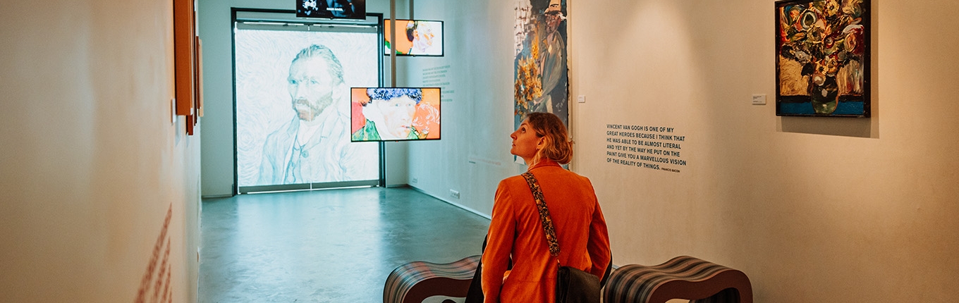 Lady looks at exhibition in Vincent van Gogh House Lady looks at exhibition in Vincent van Gogh House