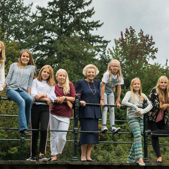 Princess Beatrix posing with her grandchildren on a bridge