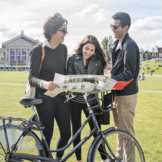 Tourists with map and rental bike on Museumsquare