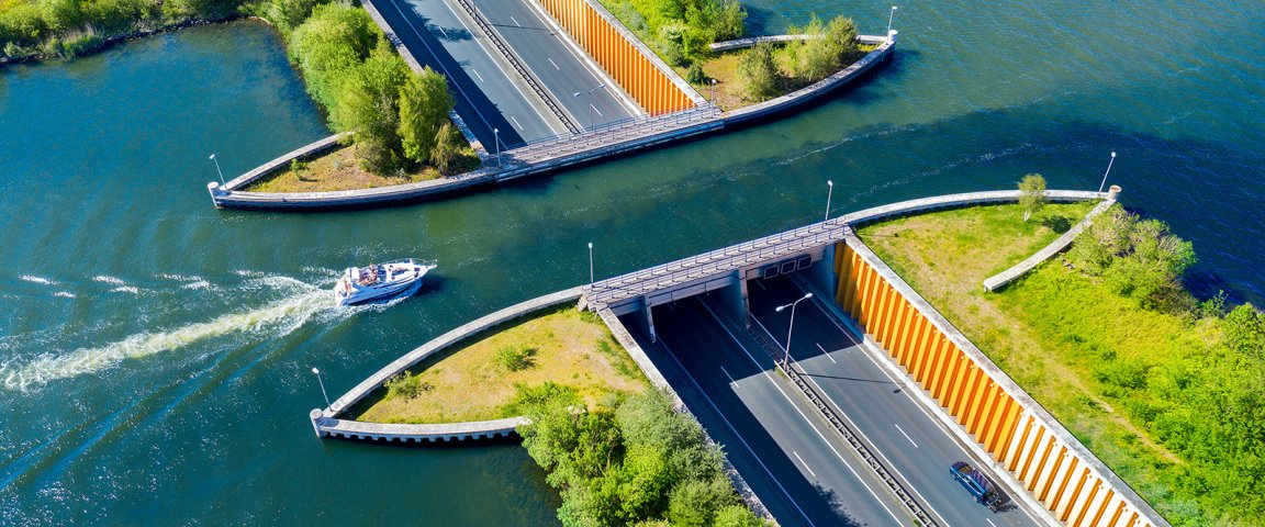 Aquaduct Veluwemeer, aerial view from the drone. A sailboat sails through the aqueduct on the lake above the highway.