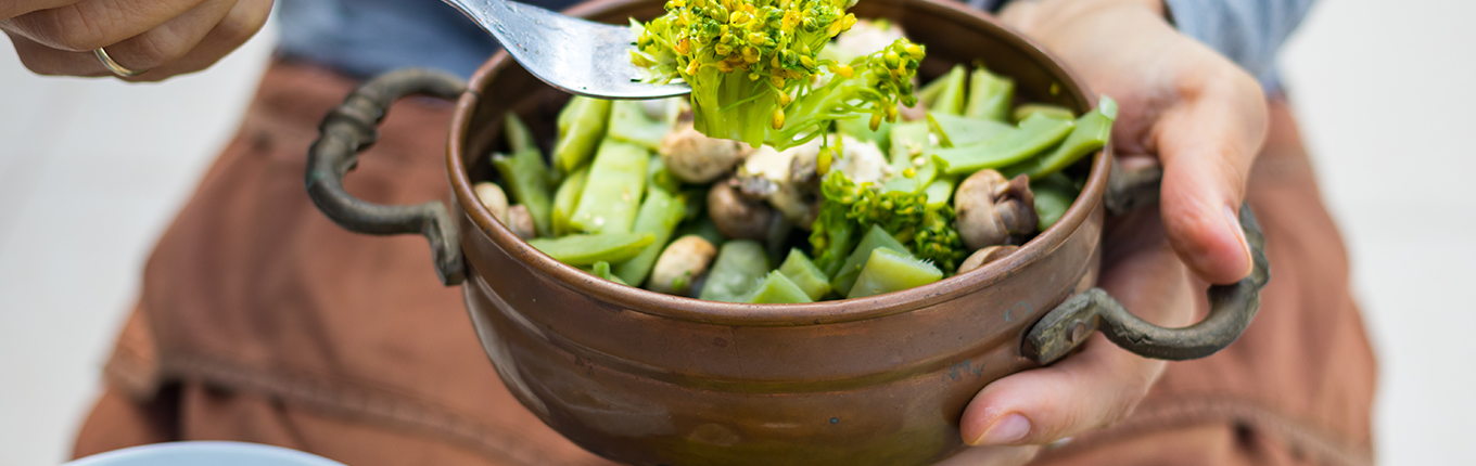 Green greens in a bowl with fork. Vegan vegetarian healty food .