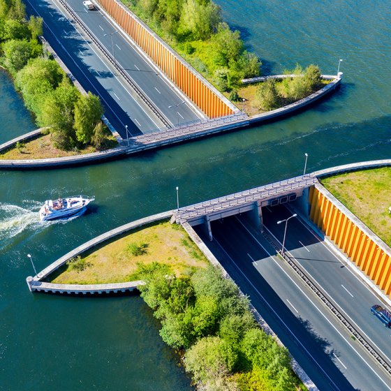 Aqueduct Veluwemeer, aerial view from the drone. A sailboat sails through the aqueduct on the lake above the highway Harderwijk