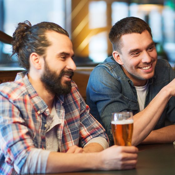 Male friends drinking beer at the pub