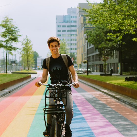 Man cycles along rainbow bike path in Utrecht