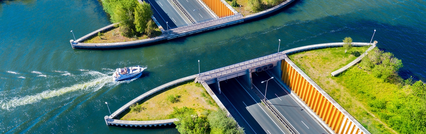 Aquaduct Veluwemeer, aerial view from the drone. A sailboat sails through the aqueduct on the lake above the highway.