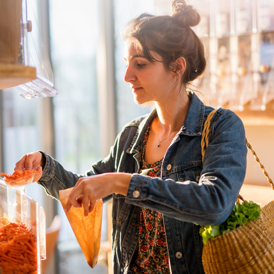 Young woman shopping in a bulk store 