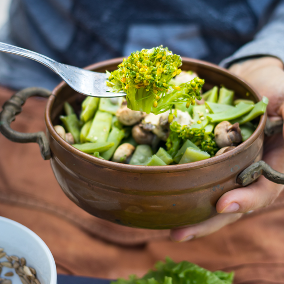 Green greens in a bowl with fork. Vegan vegetarian healty food .