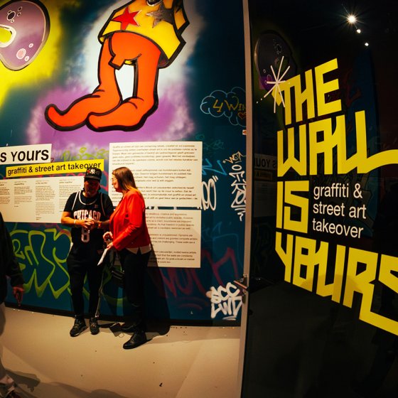 Visitors exploring graffiti and street art at the interactive The Wall is Yours exhibition in the Fries Museum