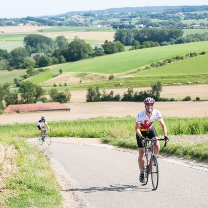 Cycling with rolling hills behind in Gulpen