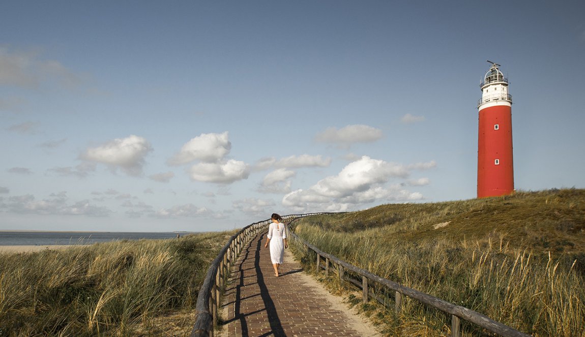 Woman at the Texel lighthouse in summer Woman at the Texel lighthouse in summer
