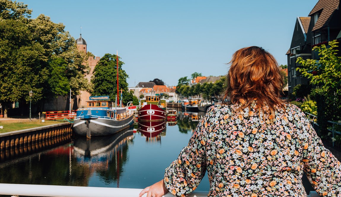 Judith Elders looks down on the water with boats from the bridge