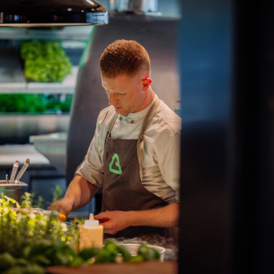 Cook in kitchen of Greenhouse in Utrecht